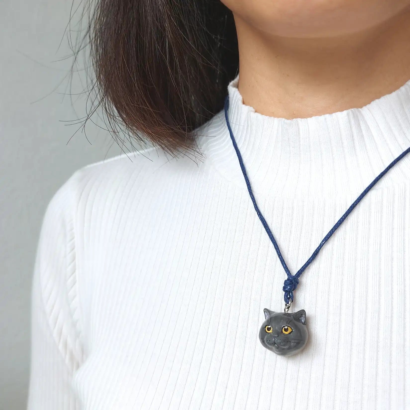 wearing a British shorthair grey solid pendant necklace