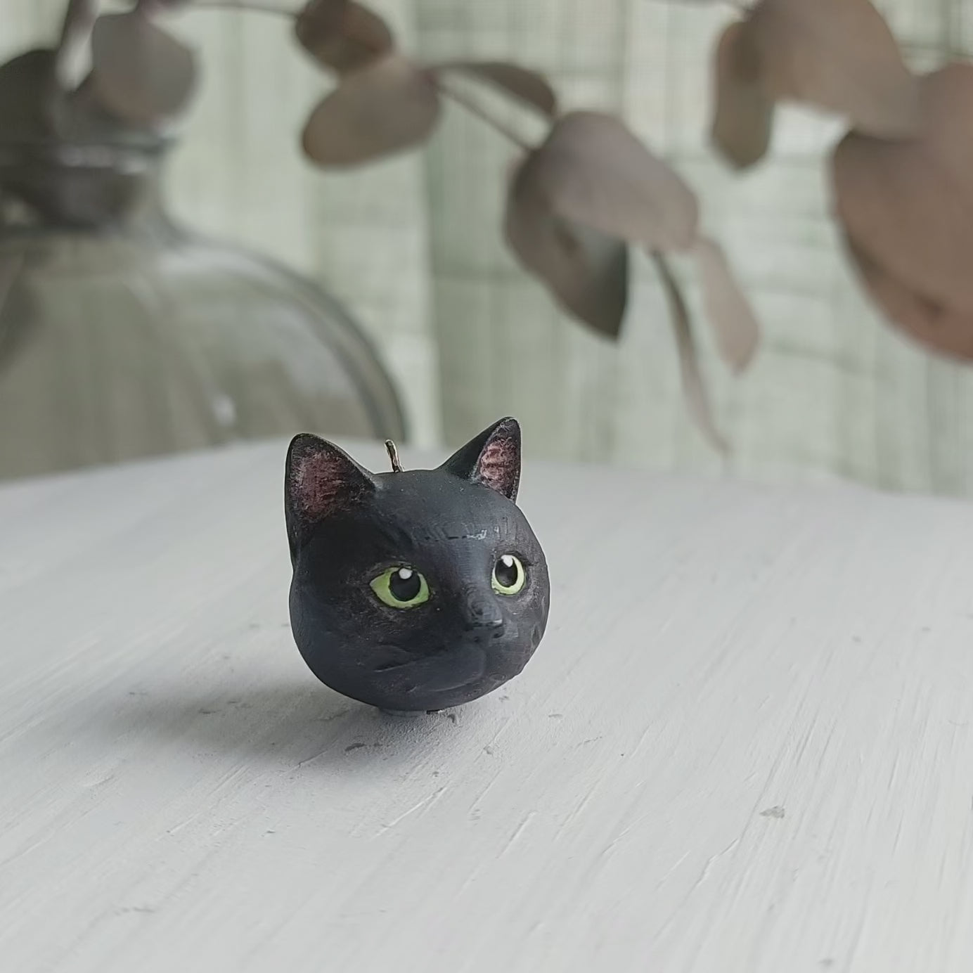 cat domestic shorthair black colour green eyes pendant turn table